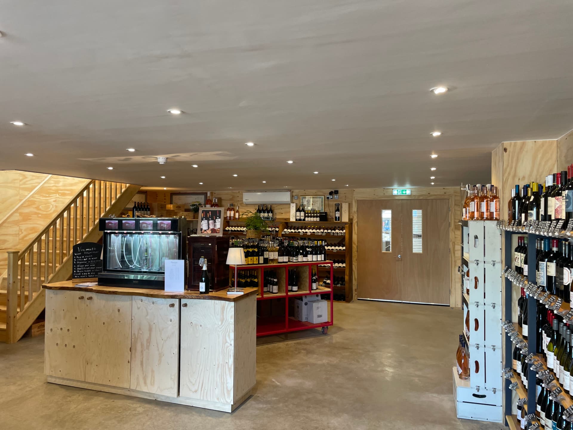 Wine shop counter with dispenser, downlights and emergency exit signage