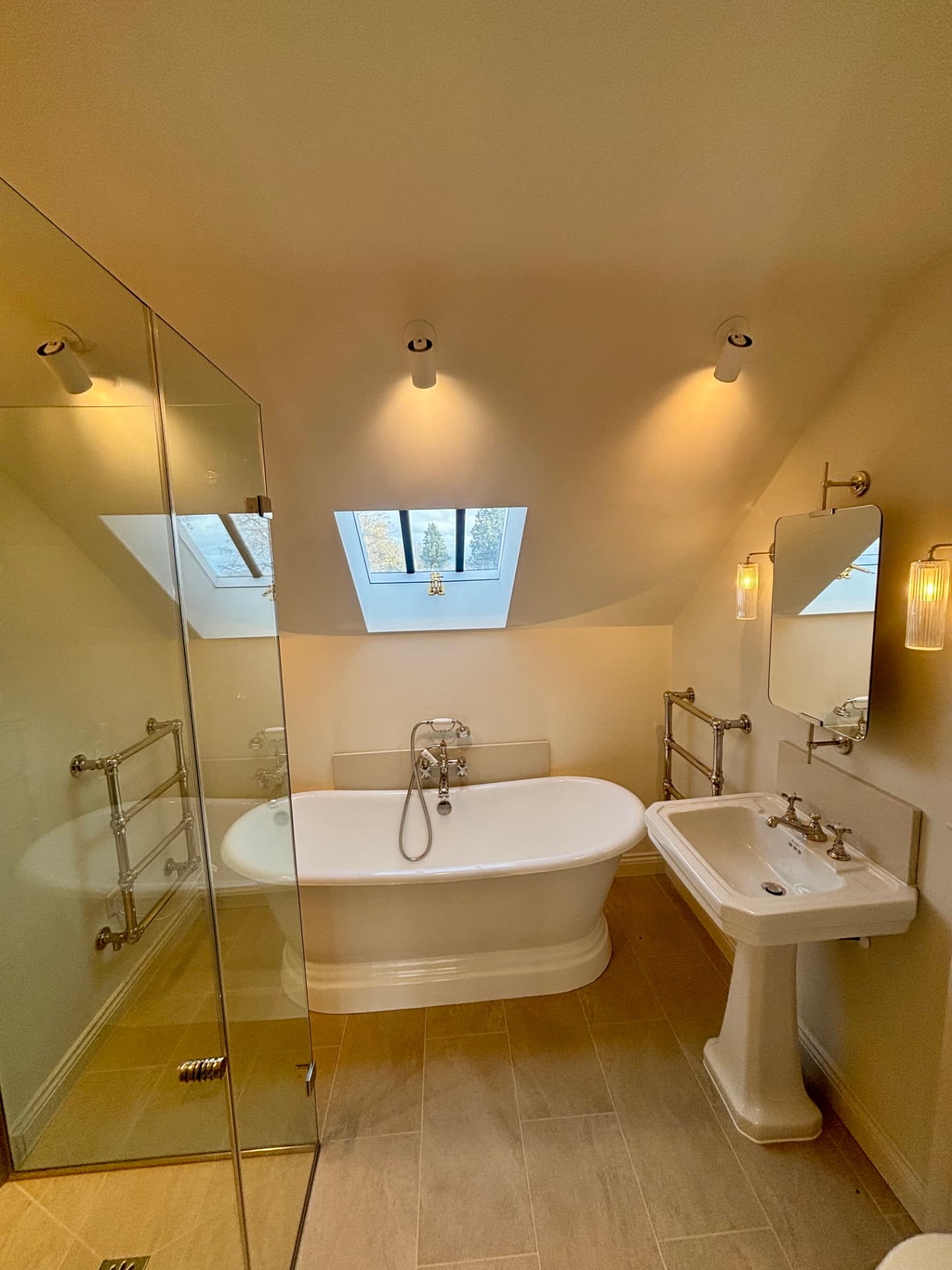 Bathroom with freestanding bath, rooflight and adjustable ceiling spots