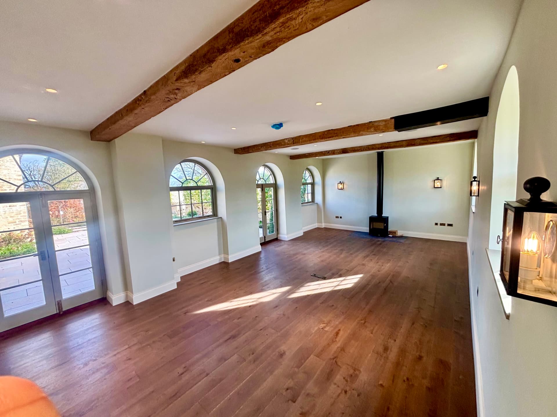 Converted barn interior with wall lighting and illuminated steps