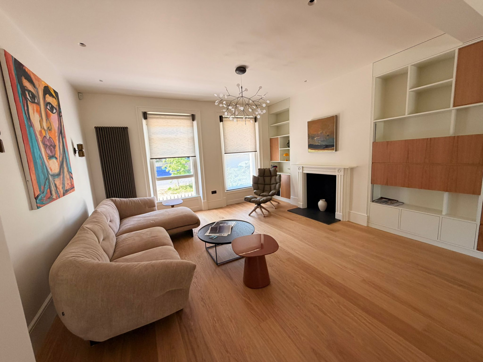 Contemporary open-plan living and dining space with concealed cove lighting and stair lighting