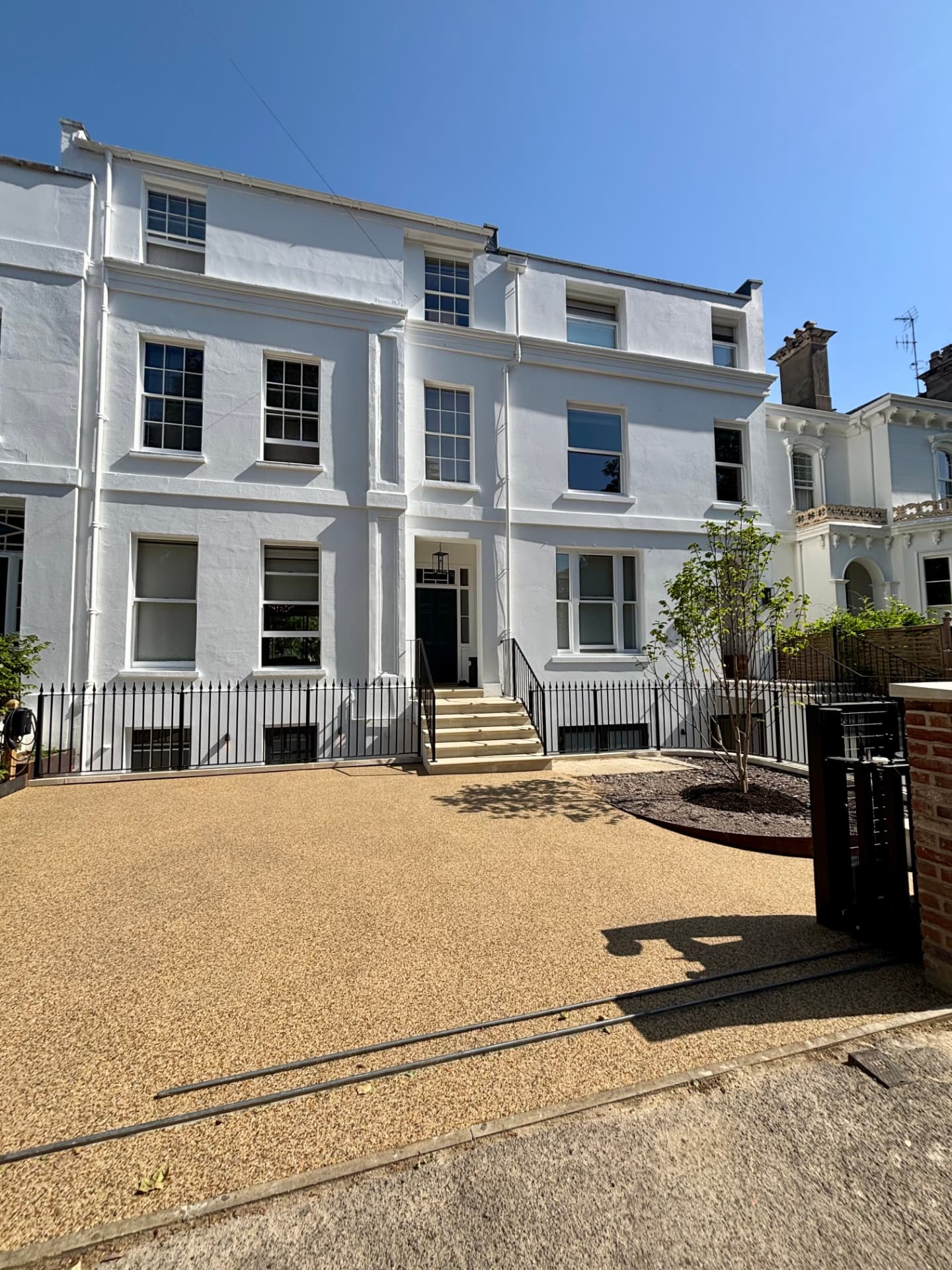 Regency townhouse frontage of a rented Cheltenham property with entrance lighting