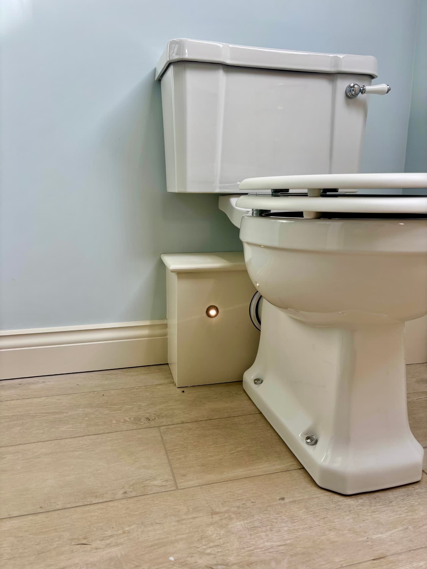 Cloakroom with low-level brass floor light beside the WC